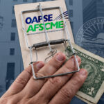 A mousetrap with cash that has caught a hand